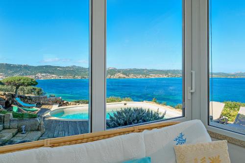 a living room with a view of the ocean at Villa Paradiso in Cala Bitta