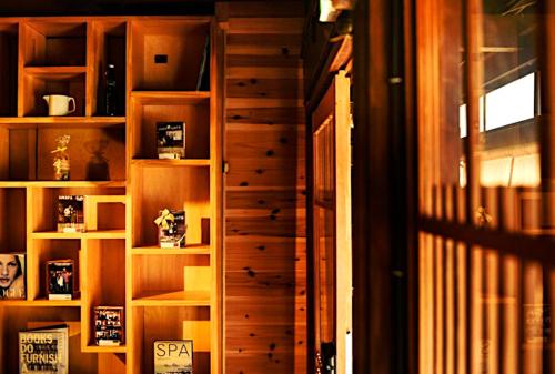 a wooden book shelf in a room at Kyoto HANATSUNAGI Hotel --- Kyoto city officially designated "KYO-MACHIYA" in Kyoto