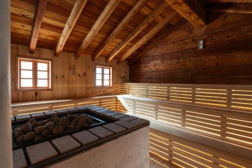 a large room with a stove in a wooden building at Hammerack Hotel, SPA & Wellness in Malborghetto Valbruna