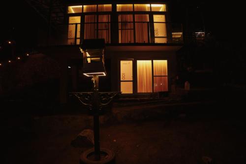 a street light in front of a house at night at Wildenest in Kanjikode