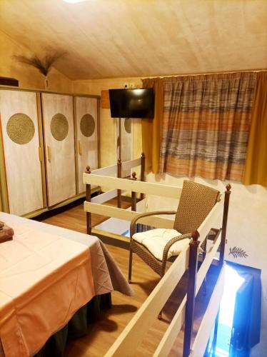 a room with two beds and a table and a chair at Home4U Κερατέα apt4, just 17km from airport in Keratea