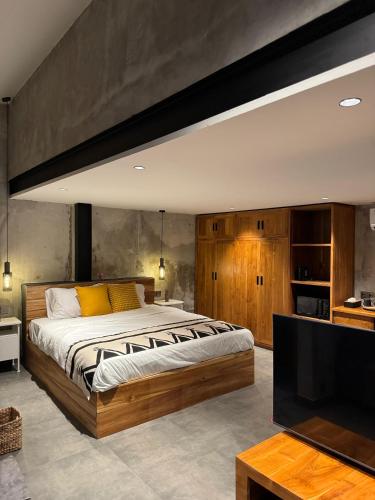 a bedroom with a large bed and a flat screen tv at Flex Living Canggu in Canggu