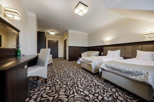 Pałac w Konarach Resort SPA & Conferenceにあるベッド