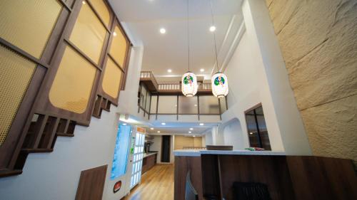 a hallway of a building with a staircase and lights at Katoya Suites Saigon Honkan 加藤部屋西貢本館 in Ho Chi Minh City