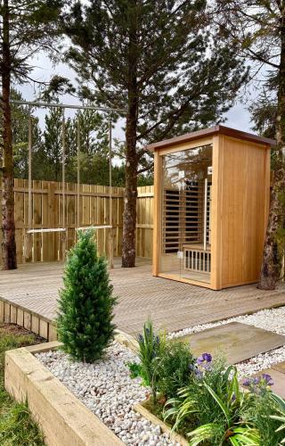 a small wooden building on a wooden deck at Mingarry Park in Acharacle