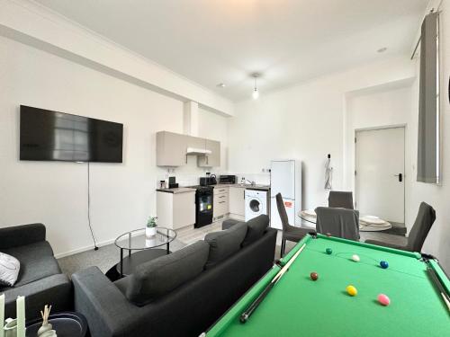 a living room with a pool table in it at City Haven - Modern 2 Bedroom in Sheffield in Sheffield