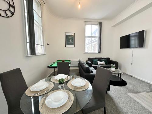 a living room with a dining room table with a pool table at City Haven - Modern 2 Bedroom in Sheffield in Sheffield
