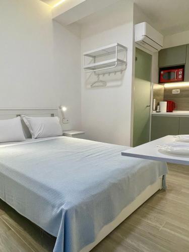 a bedroom with a large bed in a room at Agora LX Studios & Suites in Thessaloniki