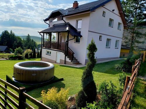a large house with a large tub in the yard at Vila Dzavric in Zlatibor