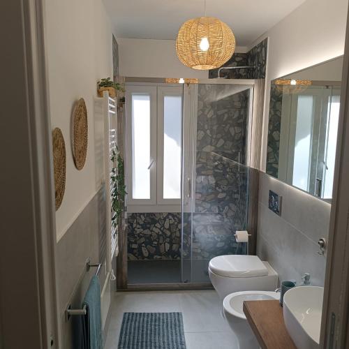 a bathroom with a shower and a toilet and a sink at Onda d'Oro in Finale Ligure