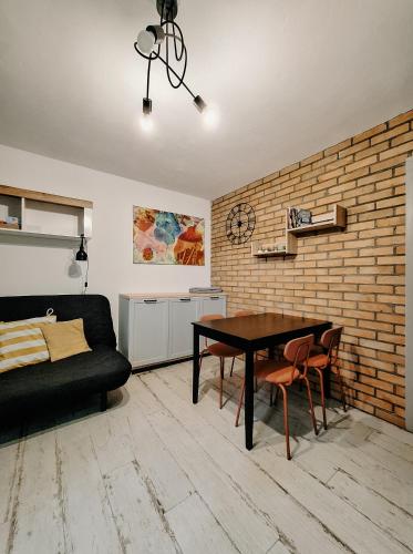 a living room with a table and a couch at Cudnie tu - Borsk in Borsk