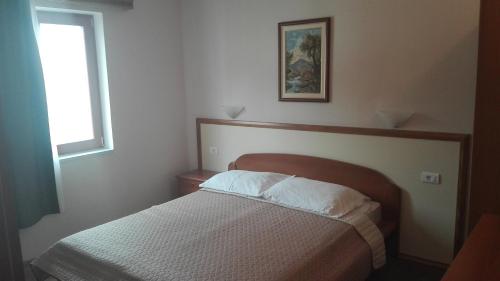 a bedroom with a bed and a window at Villa Segetski dvori - Tradition since 1964 in Trogir