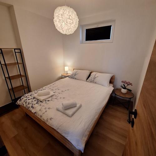 a bedroom with a bed with two towels on it at Apartment GA-JA in Ljubljana