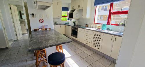 a kitchen with white cabinets and a counter top at 26 Le Paradis in Ballito