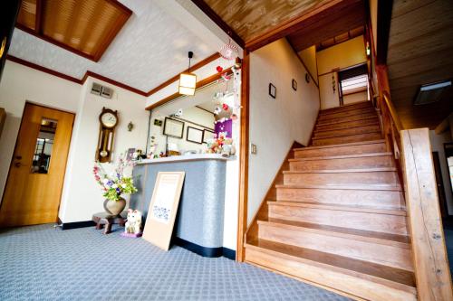 a hallway with a staircase in a building at Hinodeya in Ito
