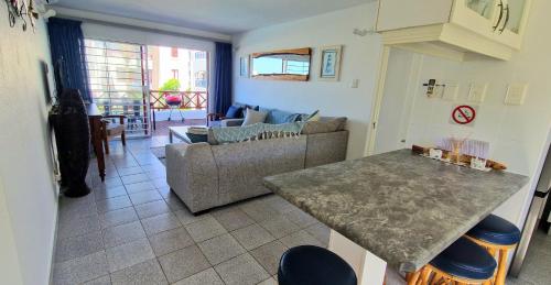 a living room with a couch and a table at 26 Le Paradis in Ballito