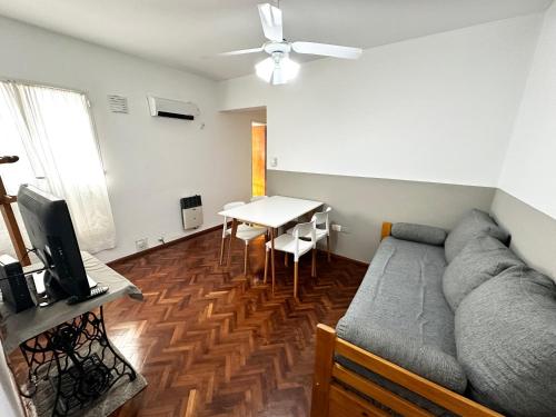 a living room with a couch and a table at Excelente ubicación en el Bv. más lindo de Rosario in Rosario