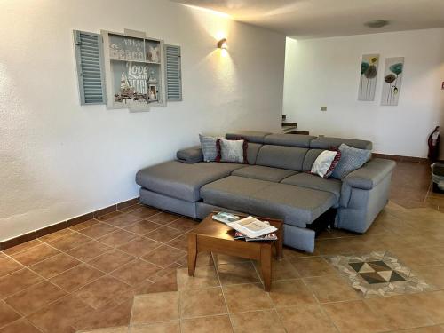 a living room with a couch and a table at Perla Marina in Porto San Paolo