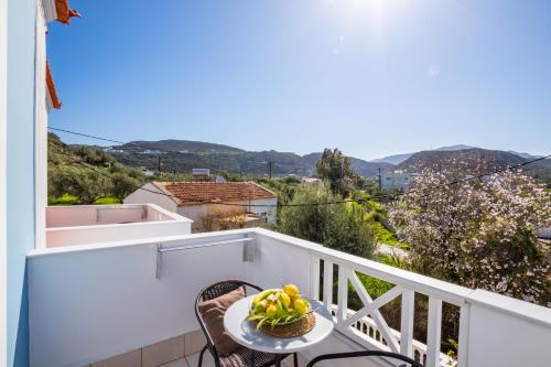 a table with a bowl of fruit on a balcony at Iliada Studios in Karpathos Town