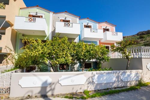a building with trees in front of it at Iliada Studios in Karpathos Town
