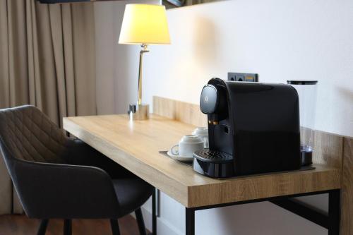 a television sitting on top of a wooden table at Eurohotel Diagonal Port in Barcelona