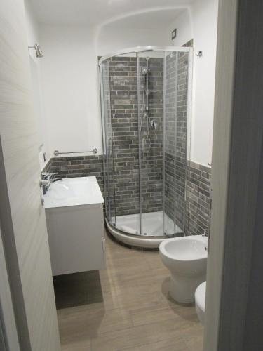 a bathroom with a shower and a toilet and a sink at Pianeta Roma 127 in Rome