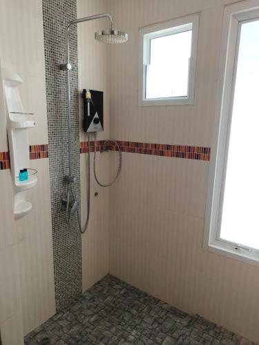 a bathroom with a shower and a window at Comfy townhouse at best location in Bangrak Beach