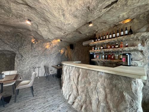 a bar in a cave with a stone wall at Lost in Sky in Yenokavan