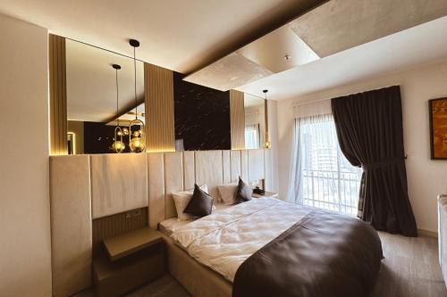 a bedroom with a large bed and a mirror at Dorana Art Hotel in Kyrenia