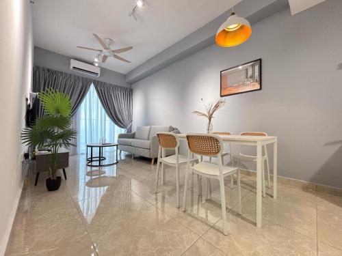 a living room with a table and chairs and a couch at ICC Ipoh Town Premium Suites By IWH Suites in Ipoh