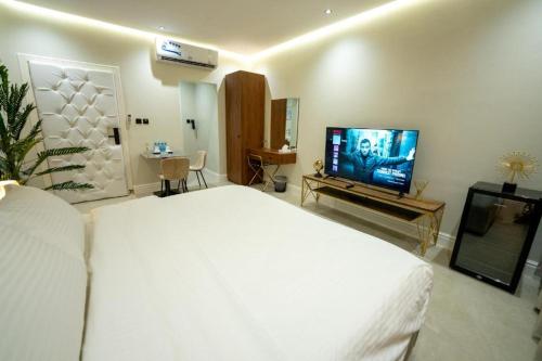 a bedroom with a large bed and a flat screen tv at 430 Guest House Residential Hotel in Islamabad