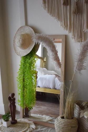 a room with a hat and a mirror and a bed at 430 Guest House Residential Hotel in Islamabad