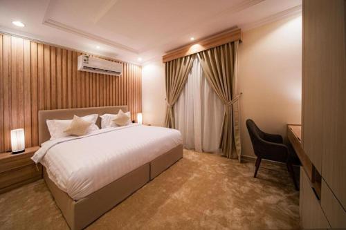 a hotel room with a bed and a desk at 430 Guest House Residential Hotel in Islamabad