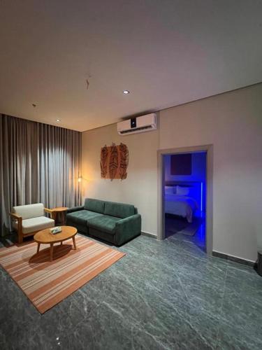 a living room with a green couch and a table at 430 Guest House Residential Hotel in Islamabad