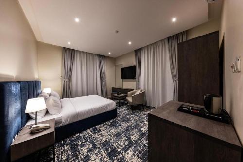 a hotel room with a bed and a television at 430 Guest House Residential Hotel in Islamabad