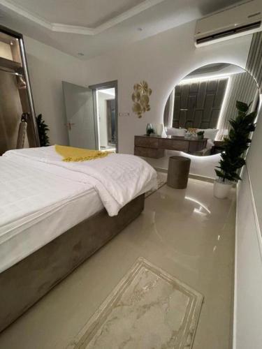 a bedroom with a large bed and a bathroom at 430 Guest House Residential Hotel in Islamabad