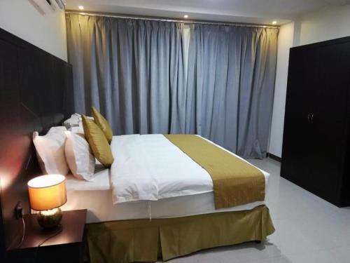 a bedroom with a large bed and a window at 430 Guest House Residential Hotel in Islamabad