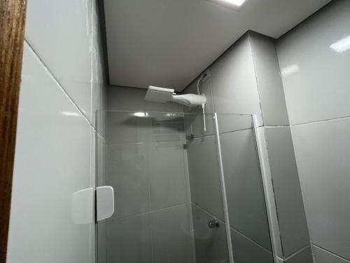 a bathroom with a shower with a glass door at Condomínio Residencial Vitória 3 in Sao Paulo