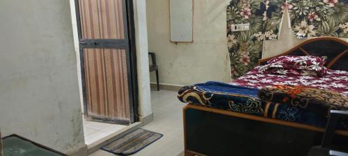 a bedroom with a bed in a room with a window at Hotel R K Palace in Rewa