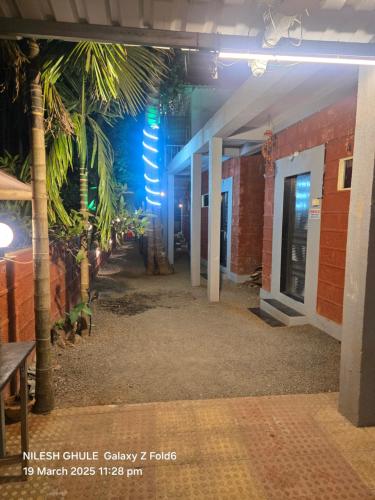 a hallway of a building with palm trees at A Ghule Patil Family Beach in Diveagar