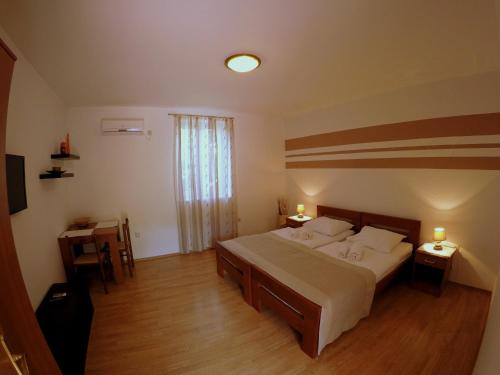 1 dormitorio con 1 cama grande y 2 mesitas de noche en Apartments Dalmatino, en Dubrovnik