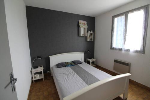 a bedroom with a white bed and a window at Maison 3 pièces Oléron 6 couchages SAINT GEORGES D'OLERON SGO000-434 in Saint-Georges-dʼOléron
