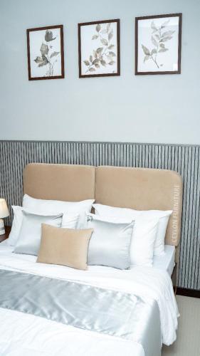 two beds with white pillows in a bedroom at Spacious 3BR Luxury Apartment Trizen Colombo 2 Near City Centre in Colombo
