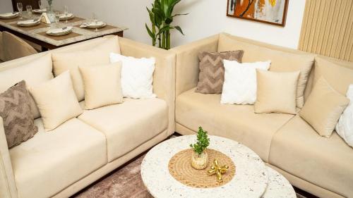 a living room with two white couches and a table at Spacious 3BR Luxury Apartment Trizen Colombo 2 Near City Centre in Colombo
