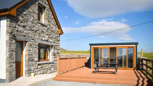 a house with a deck with a bench on it at Doolin Heights Apartment in Doolin