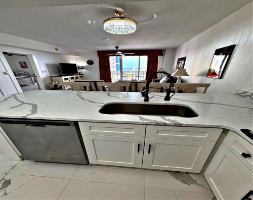 a kitchen with a sink and a counter top at Totally Updated 1 BR Deluxe Jacuzzi Suite - Wyndham Ocean Walk 2429 - Vacation in Resort luxury in Daytona Beach