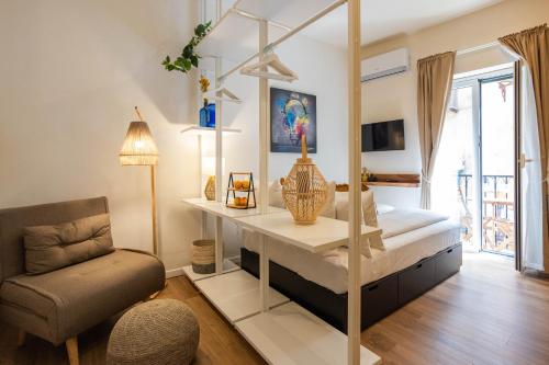 a bedroom with a bed with a table and a chair at Le Terrazze dei Candelai "boutique apartments" in Palermo