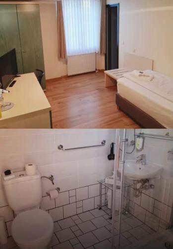 a bathroom with a toilet and a sink and a bed at Land-Gut-Hotel- Weisser Schwan in Zossen