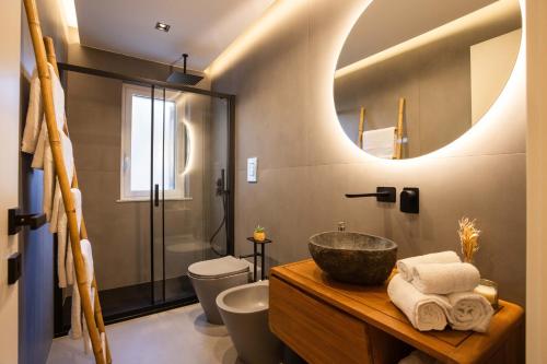 a bathroom with a sink and a toilet and a mirror at Le Terrazze dei Candelai "boutique apartments" in Palermo