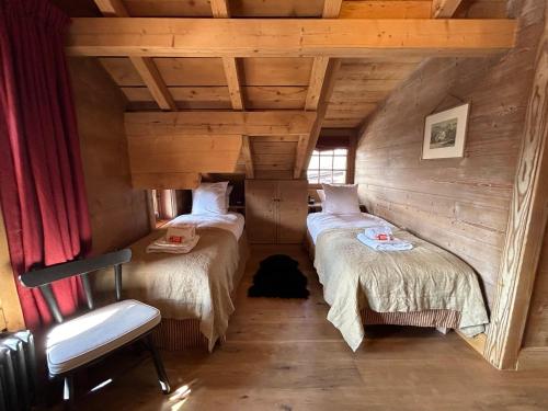 a room with two twin beds in a cabin at Unique, High-Design 6 Bedrooms Chalet in Villars Centre in Ollon